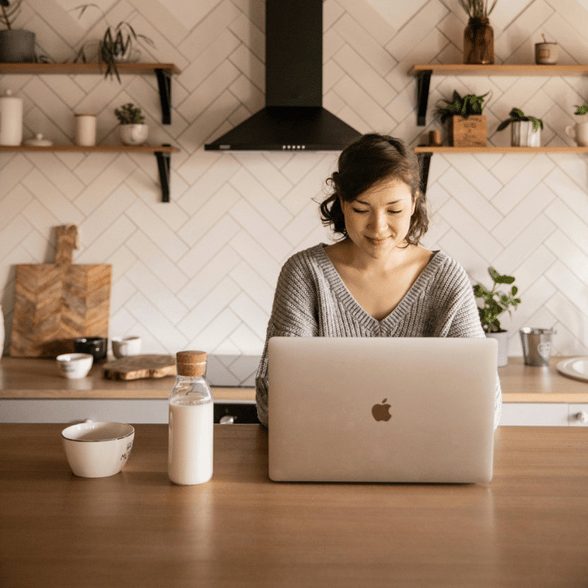 Business owner using laptop in kitchen
